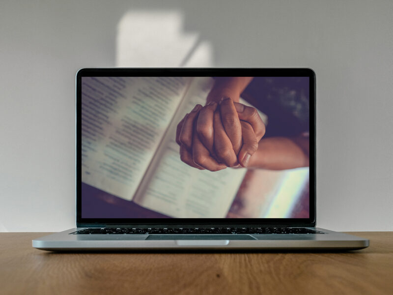 Laptop showing praying hands